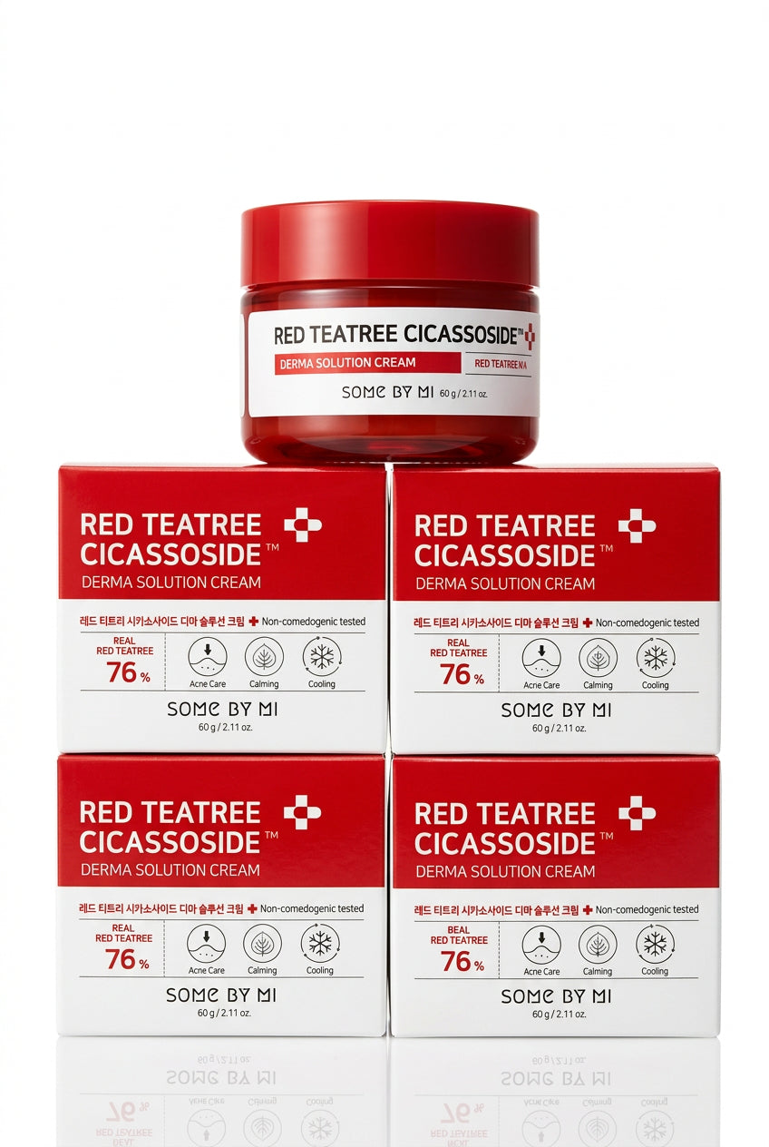 A stack of red and white boxes of Red Teatree Cicassoside Derma Solution Cream, with one open jar with a red lid placed on top, set against a plain white background. in Dubai 