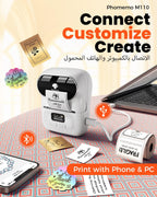 Phomemo M110 label printer with smartphone, laptop, and printed labels on a patterned surface.